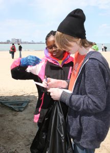 Students picking up trash from beach on Ohio Street