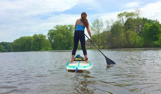Woman stand-up paddle boarding on the Sheboygan River