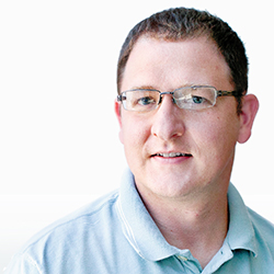 headshot of Jay Beugly in a blue, collared shirt