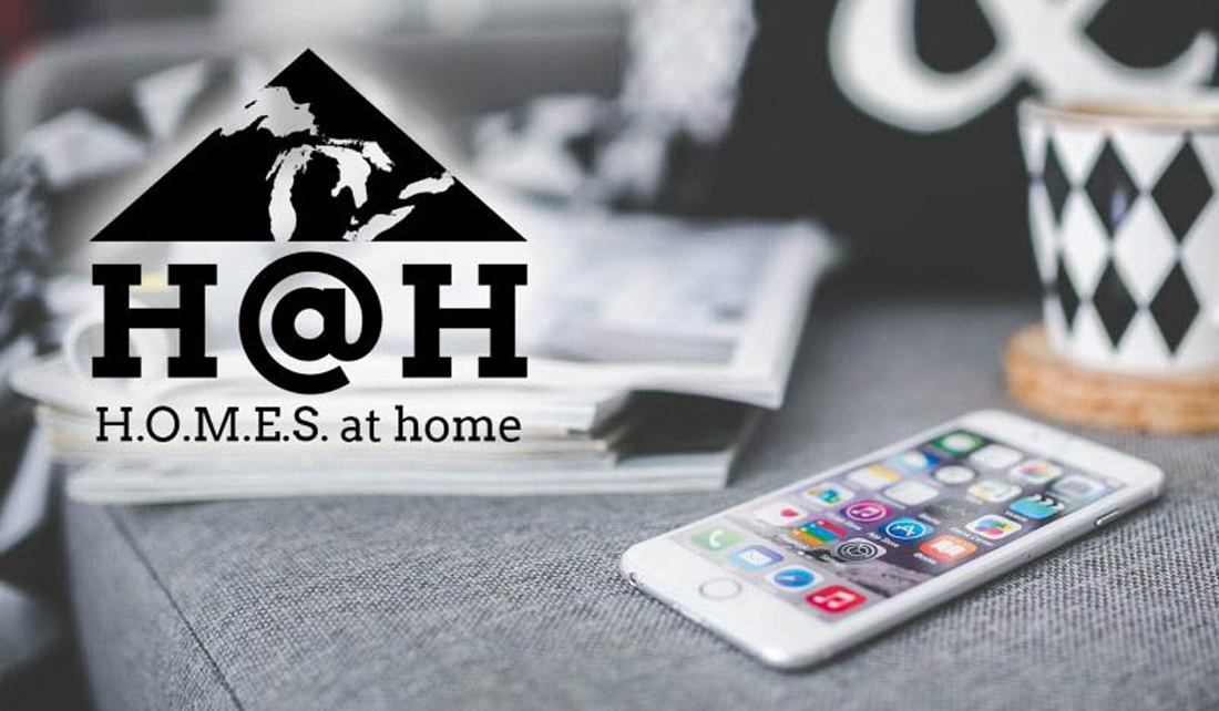 photo of couch with smartphone and a cup of coffee, with the HOMES at Home logo overlaid