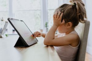 Girl completes educational activity on tablet