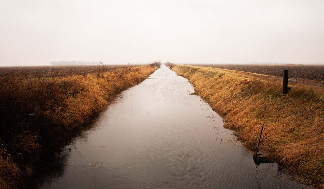 water flowing between farm fields in Indiana