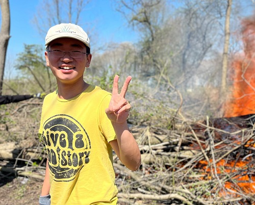 Intern Gary Liu helping with a site cleanup