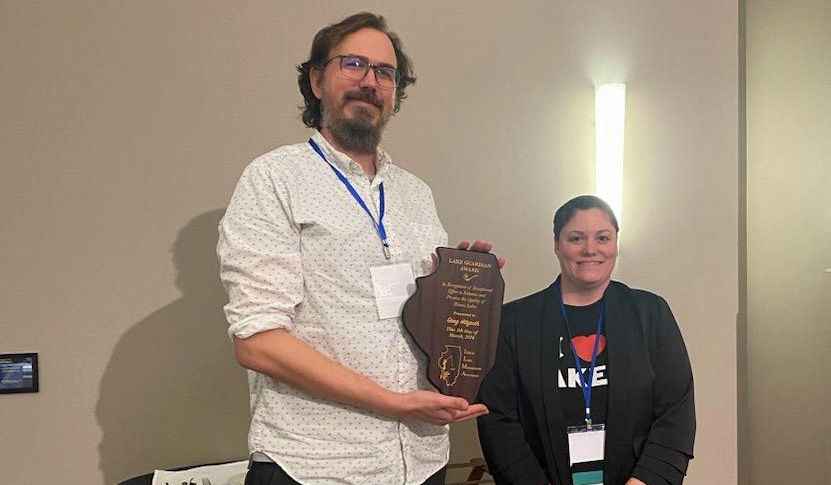 Greg Hitzroth holds ILMA Lake Guardian Award