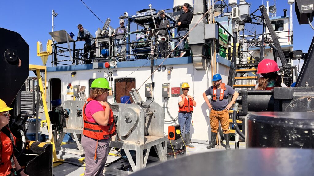 Individuals work on the deck of a boat
