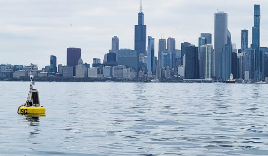 A yellow buoy sits in Lake Michigan waters along the Chicago skyline.