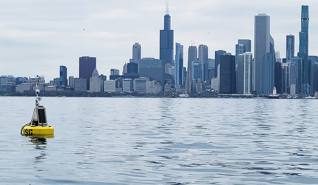 A yellow buoy sits in Lake Michigan waters along the Chicago skyline.